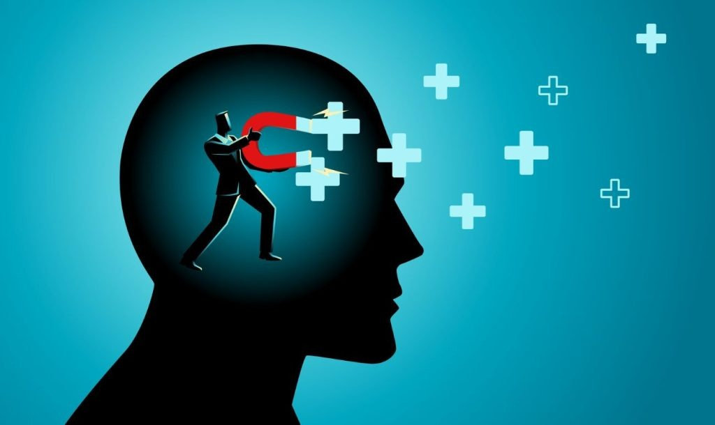 تصویر انسان و یک آهنربا و علامت مثبت-آشکارسازی خواسته